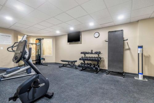 a gym with cardio equipment and a tv in a room at Sleep Inn & Suites in Newport News