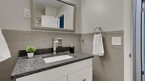 a bathroom with a sink and a mirror at Capital City Delight-Close to Speedway Downtown and easy access to Highways in Indianapolis