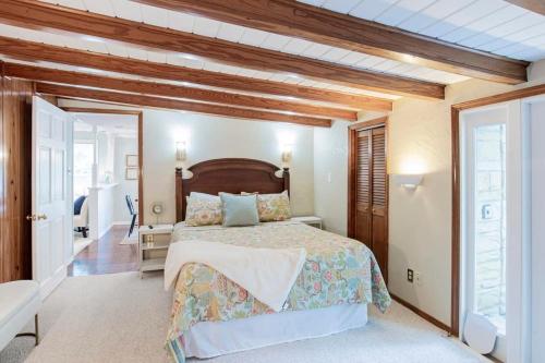 a bedroom with a large bed with a wooden headboard at Dozing on Dog River- River Access Dock Yard in Tillmans Corner