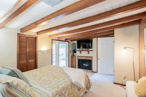 a bedroom with a bed and a fireplace at Dozing on Dog River- River Access Dock Yard in Tillmans Corner