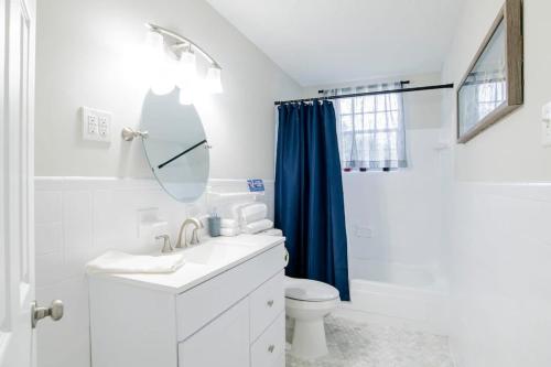 a bathroom with a sink and a toilet and a mirror at Paradise Near the Port in Mobile