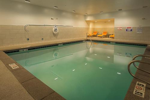 a large swimming pool in a building at Holiday Inn Express & Suites Boise Airport by IHG in Boise