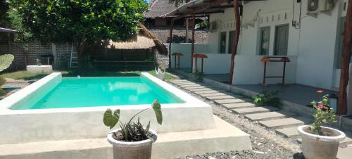 a swimming pool in the backyard of a house at Scar Reef Homestay in Jereweh