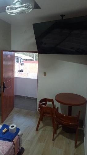 a room with a table and a table and a chair at Hospedaje Mi Casita - Pucallpa -Selva in Puerto Callao