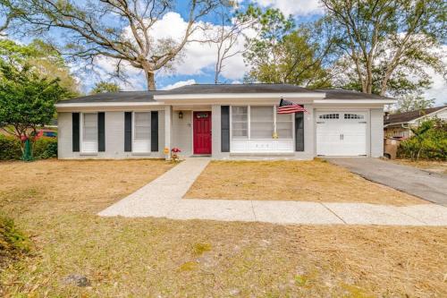 a small white house with a red door at Enchanting Forestwood Retreat in Mobile