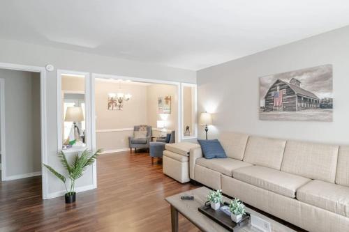 a living room with a couch and a table at Enchanting Forestwood Retreat in Mobile