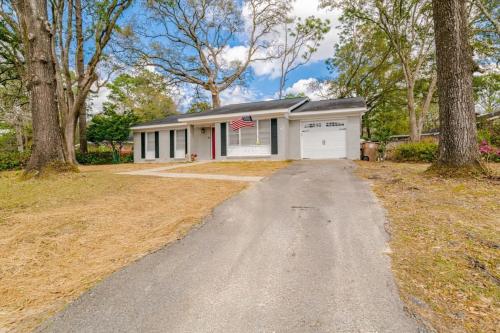 a house with a garage with a flag on it at Enchanting Forestwood Retreat in Mobile