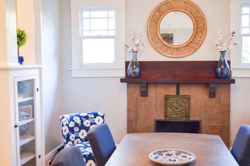 a dining room with a table and a mirror at Modern & Centrally Located Stay at Calypso Dreams in Mobile