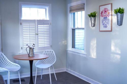 a dining room with a table and chairs and a window at Modern & Centrally Located Stay at Calypso Dreams in Mobile