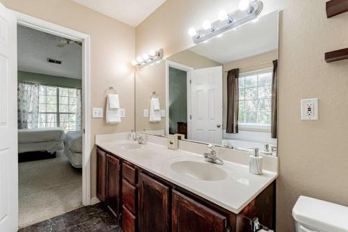 baño con lavabo y espejo grande en Aerie Oaks Cottage-5min to Lake, 20min to Columbia en Lexington