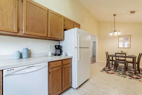 a kitchen with a white refrigerator and a table at Aerie Oaks Cottage-5min to Lake, 20min to Columbia in Lexington