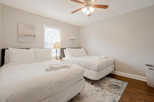 a bedroom with two beds and a ceiling fan at Fenced Yard 10 Mins to Lake Murray in Columbia