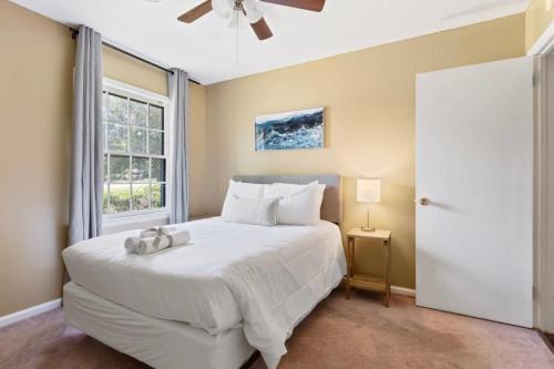 a bedroom with a white bed and a window at Firepit & Patio- Mins to Dining- The Vaughnique in Montgomery