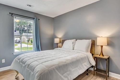 a bedroom with a large bed and a window at Near Hospital and Downtown- Lodging on Leghorn in Savannah