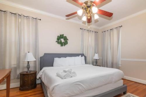 a bedroom with a bed with a ceiling fan at The Parkside Cottage Lakebottom Park at Doorstep! in Columbus