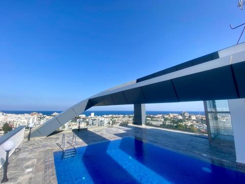 a swimming pool on the roof of a house at Nurel Shark Residence in Kérynia