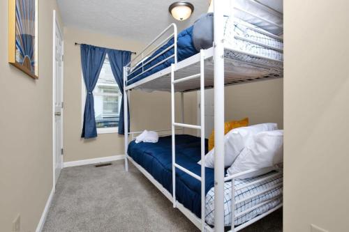 a bunk bed room with two bunk beds in it at The Precious Pearl- Close to downtown, Ft Bragg, in Fayetteville