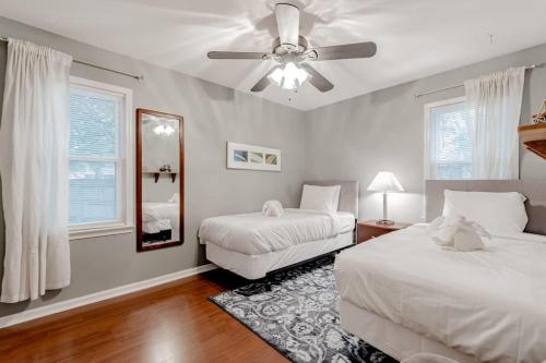a bedroom with two beds and a ceiling fan at Settle Inn-- 10mi to Columbia, Mins to Lake Murray in Irmo
