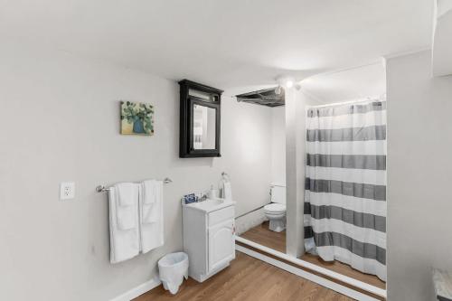 a bathroom with a toilet and a shower at Near Hospital & Dining- Beds on Broadmoor - Unit B in Birmingham