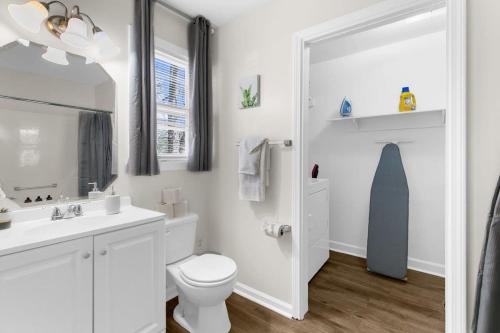 a white bathroom with a toilet and a sink at Mins to Hospital Airport & Dining- Rooms on Rose in Birmingham