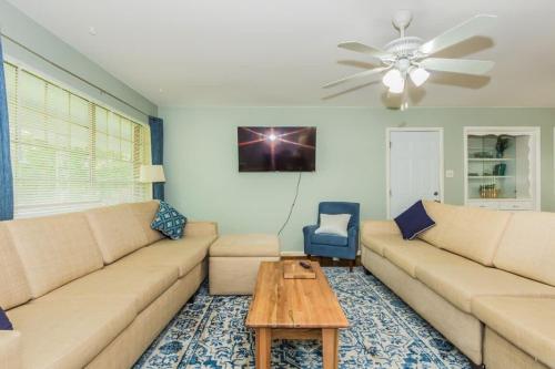 a living room with a couch and a table at Mins to Zoo Hospital & UA - Broadmoor Bungalow in Little Rock