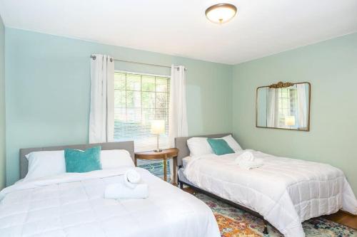 a bedroom with two beds and a window at Mins to Zoo Hospital & UA - Broadmoor Bungalow in Little Rock