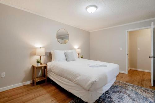a bedroom with a large white bed and a mirror at Mins to USC Hospital Zoo Columbia Duet-Unit A in West Columbia