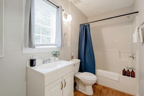 a bathroom with a sink and a toilet and a window at Mins to USC Hospital Zoo Columbia Duet-Unit A in West Columbia