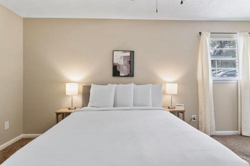 a bedroom with a large white bed and two lamps at Near Parks Dining & Shopping - Glade Park Gem in Montgomery