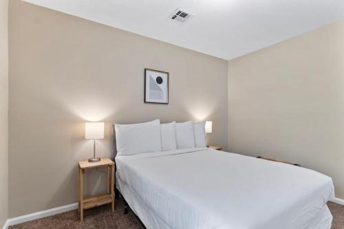 a bedroom with a large white bed and a lamp at Near Parks Dining & Shopping - Glade Park Gem in Montgomery