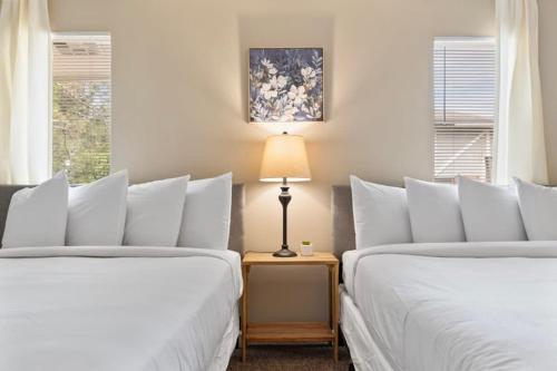 a bedroom with two beds and a table with a lamp at Near Parks Dining & Shopping - Glade Park Gem in Montgomery