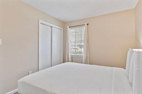 a white bedroom with a large bed and a window at Near Parks Dining & Shopping - Glade Park Gem in Montgomery