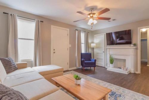 a living room with a couch and a ceiling fan at The Delightful Doubles- Unit B- Centrally Located in Columbus