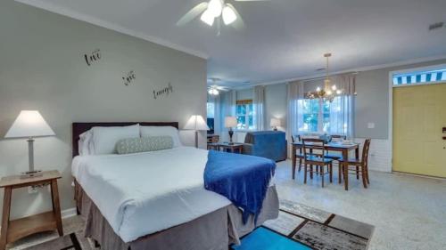 a bedroom with a large bed and a dining room at Studio with Gazebo-Swanky Savannah Style in Savannah