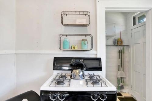 a kitchen with a stove with a tea kettle on it at Charming Midtown Apt - Hannon Hideaway Unit C in Mobile