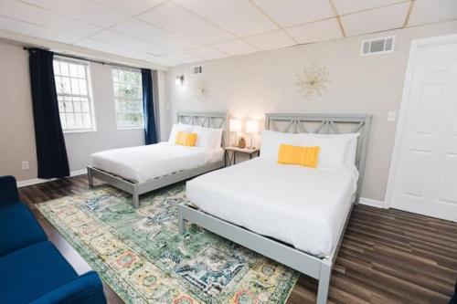 a bedroom with two beds and a blue couch at Forest Park Place in Birmingham