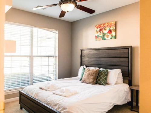 a bedroom with a large bed with a ceiling fan at The Lucky Charm Sunny Screened Porch Near USC&Base in Columbia