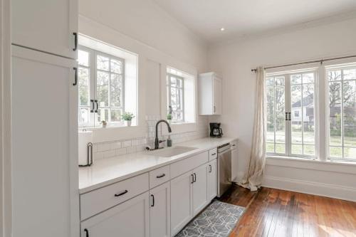 a white kitchen with a large sink and windows at Mins to Cruise Terminal&Downtown- Sunny Splendor in Mobile
