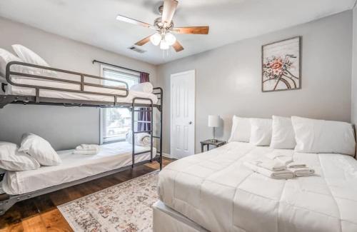 a bedroom with two bunk beds and a ceiling fan at Fenced Yard - Comfy & Convenient in Cordova in Memphis