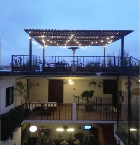 a building with a pergola with lights on it at Ganesha Hotel in San Cristóbal de Las Casas