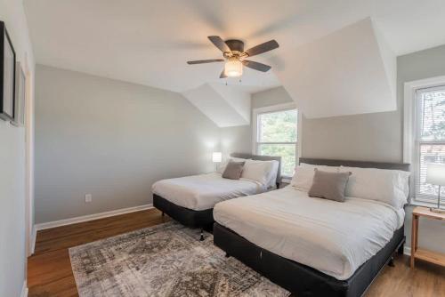 a bedroom with two beds and a ceiling fan at Rocket City Retreat- Mins to everything in Huntsville