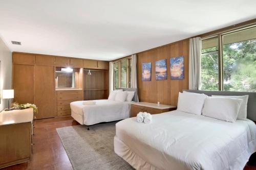 a hotel room with two beds and a room with at Midcentury Modern - Pool & Hot tub - Retro Retreat in Mobile