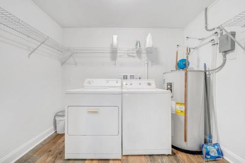 a laundry room with a washer and a refrigerator at Cottage in the Pines in Rocky Mount