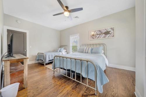 a bedroom with a bed and a ceiling fan at Cottage in the Pines in Rocky Mount