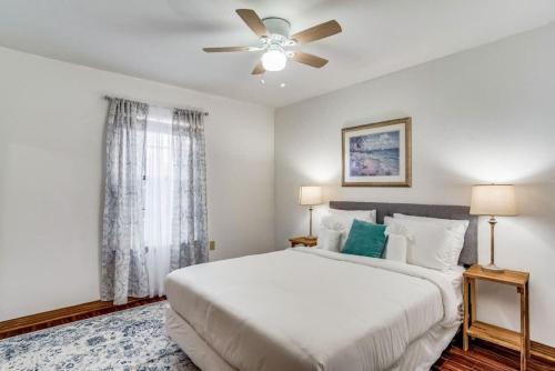 a bedroom with a white bed and a ceiling fan at Brilliant in Bellview-Back unit-- Mins to NAS Pensacola, Beach, Shopping in Pensacola
