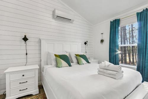 a white bedroom with a large white bed and a window at Tiny House Near Hiking- Green Mountain Getaway in Owens Cross Roads