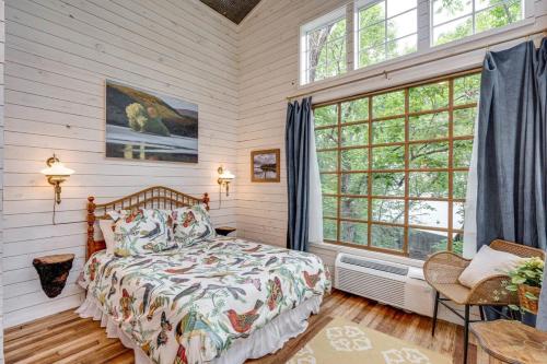 a bedroom with a bed and a large window at Treetop Hideaways: The Dogwood Treehouse in Chattanooga