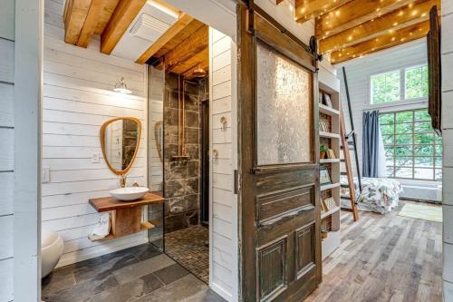 a bathroom with a sink and a mirror at Treetop Hideaways: The Dogwood Treehouse in Chattanooga