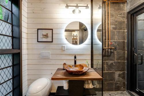 a bathroom with a sink and a shower at Treetop Hideaways: The Wood Lily Treehouse in Chattanooga