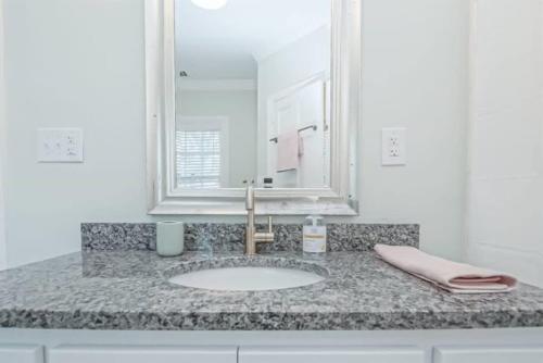 een badkamerbar met een wastafel en een spiegel bij California Dreamin'- Close to Medical District in Augusta